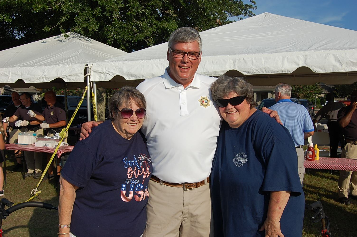Sheriff Weaver pictured with two residents at a past National Night Out event.
