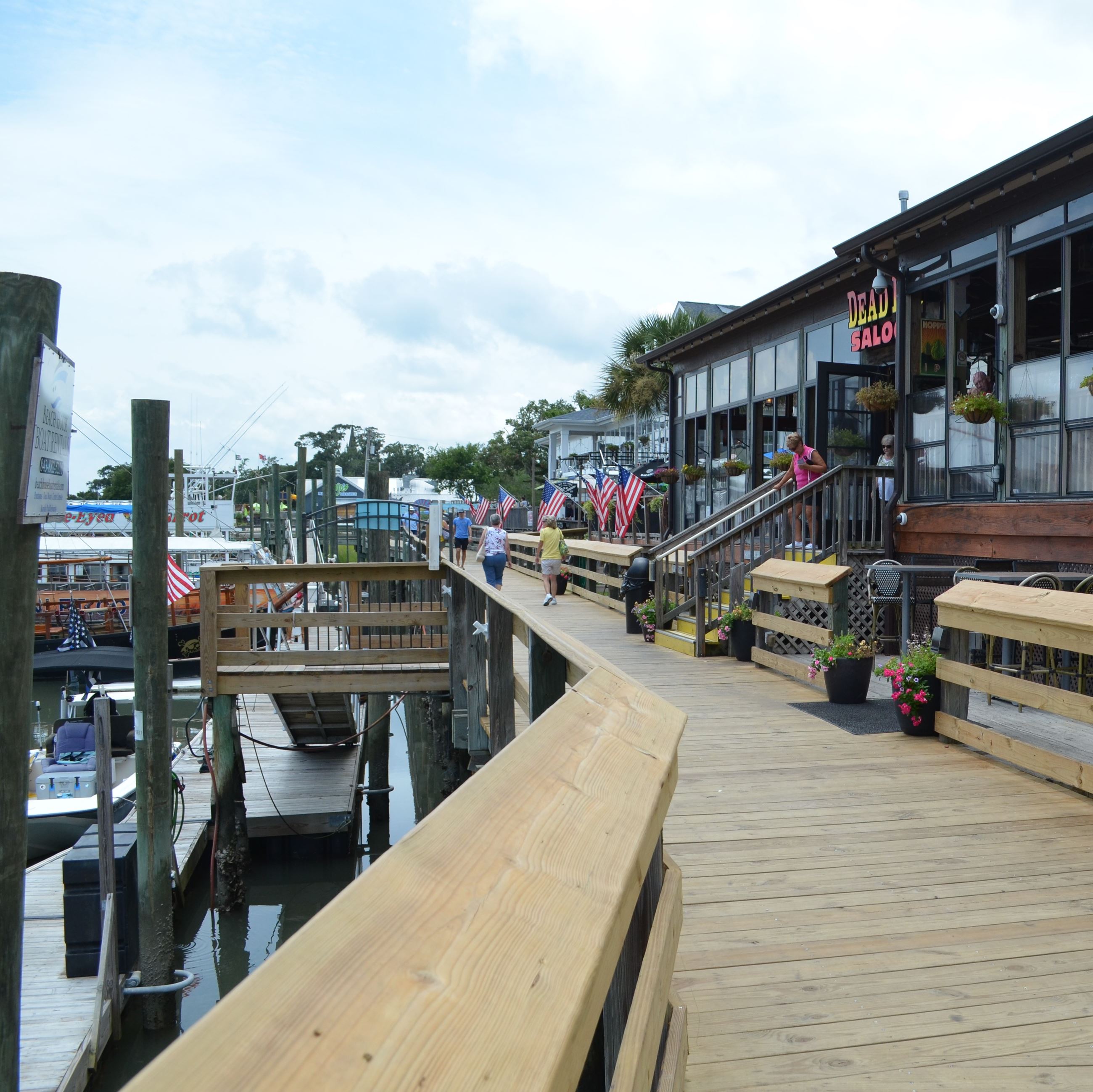 Customers file onto the MarshWalk from a restaurant.