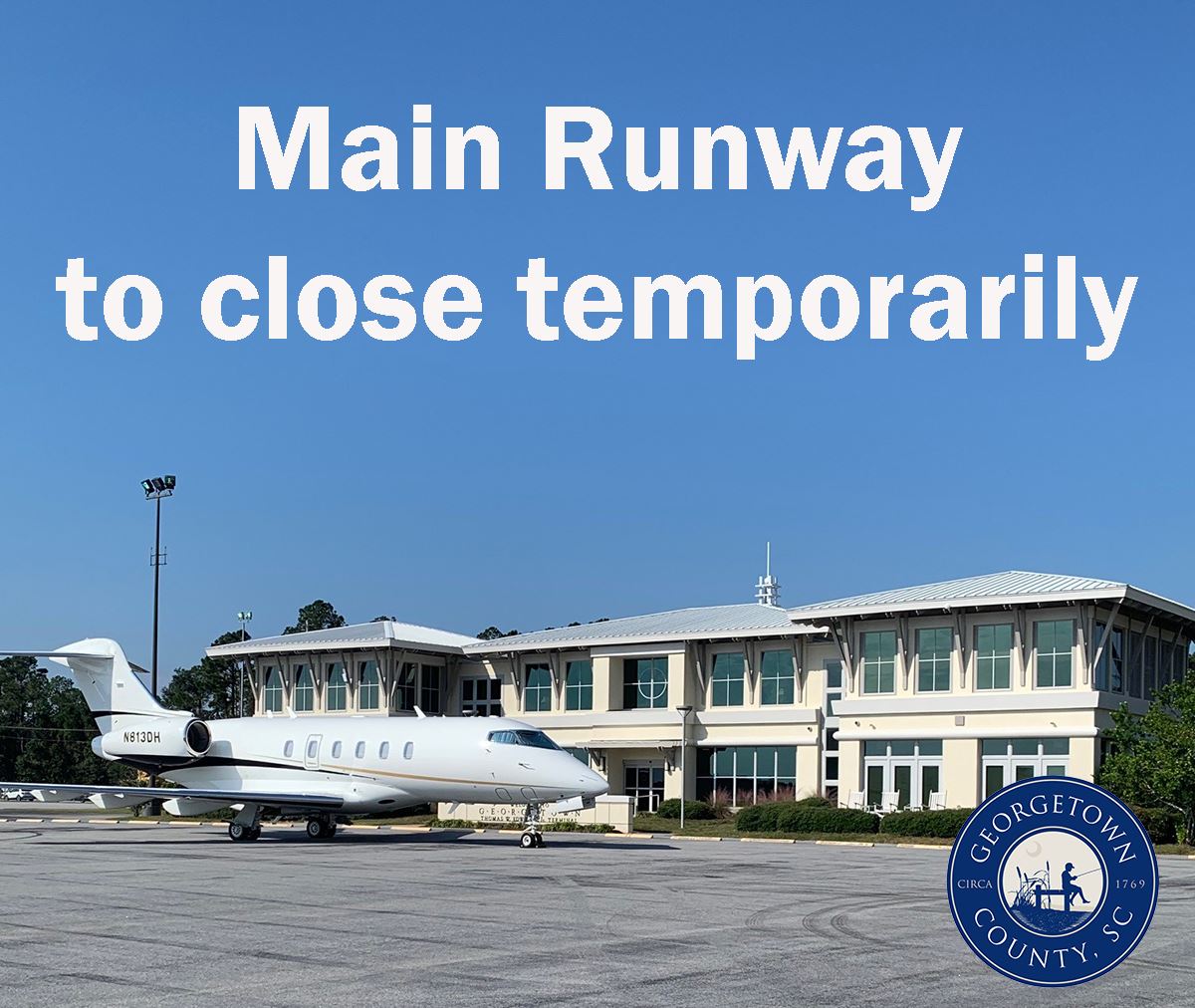 A large plane sits on the tarmac in back of the Georgetown County Airport