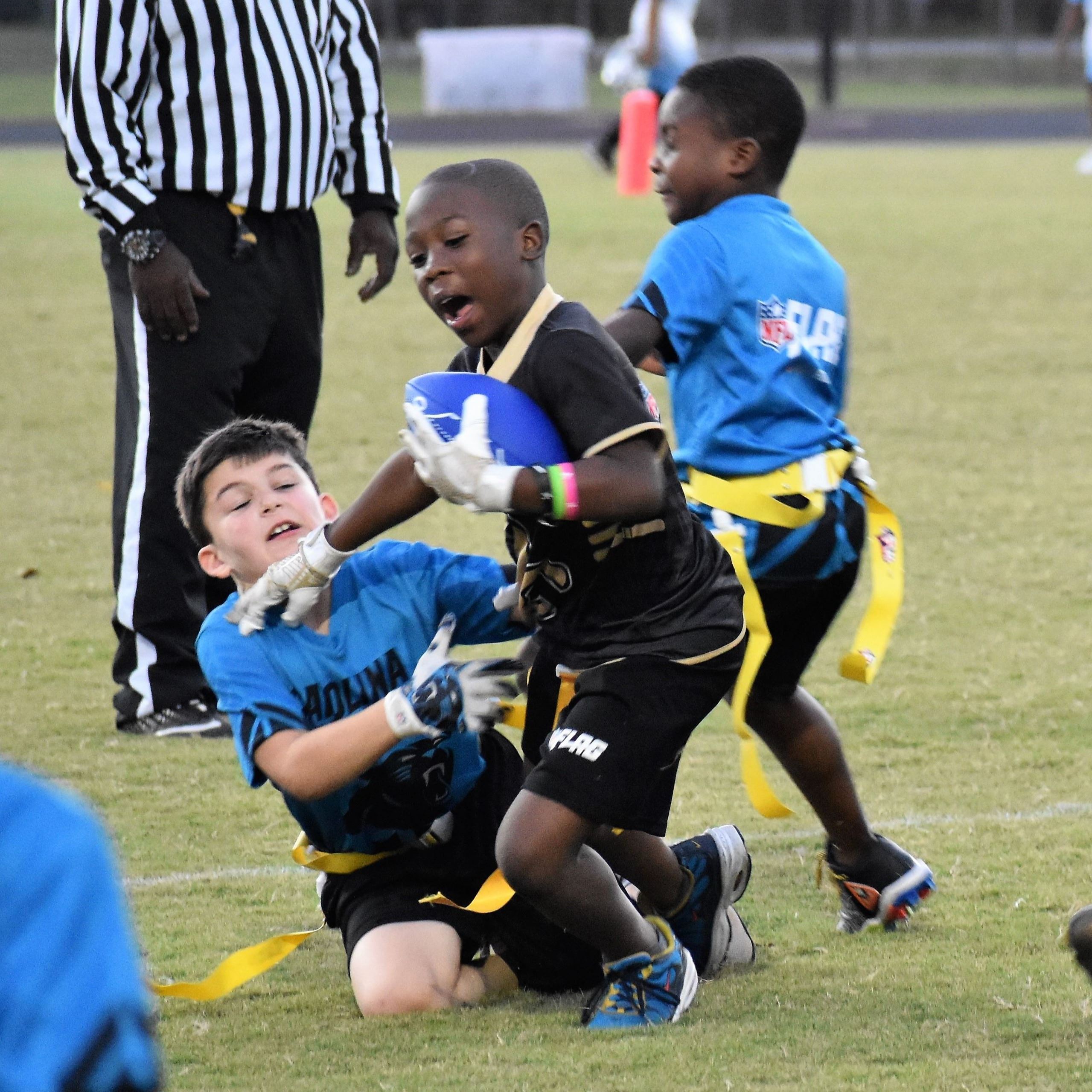Young boys playing flag football