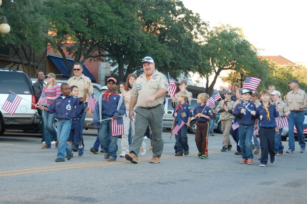 A Boy Scout troop marching in a Veterans Day Parade