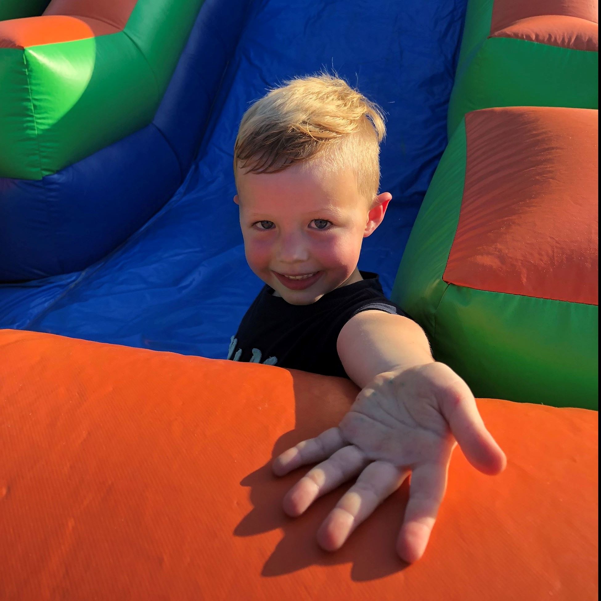 A young boy comes down a colorful slide during a previous National Night Out event.