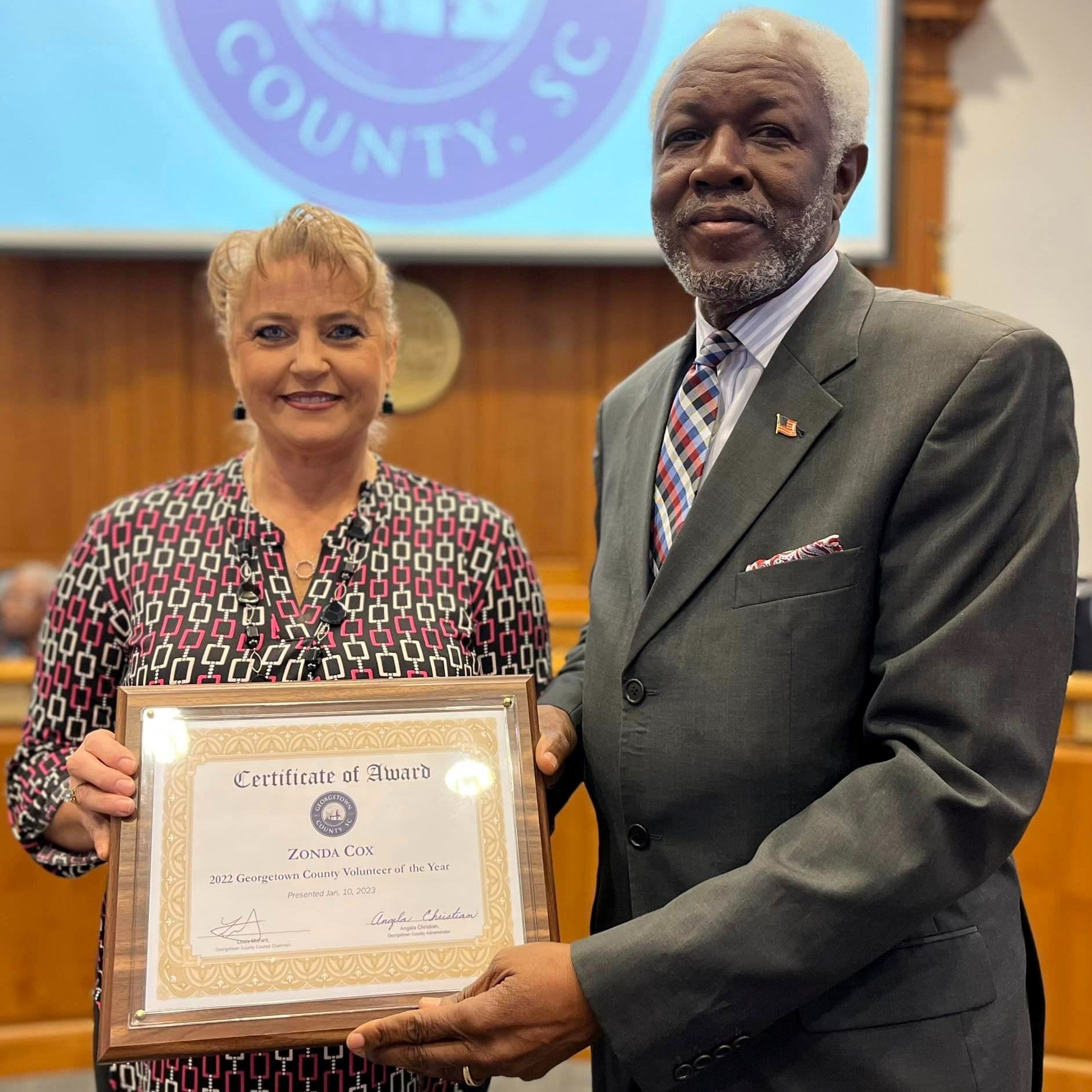 Zonda Cox pictured accepting a plaque from Council Chairman Louis Morant