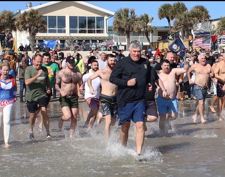 Fundraisers race into the ocean during the 3rd annual GCSO Polar Plunge