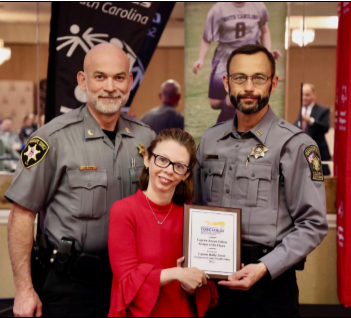 Three people during a plaque presentation