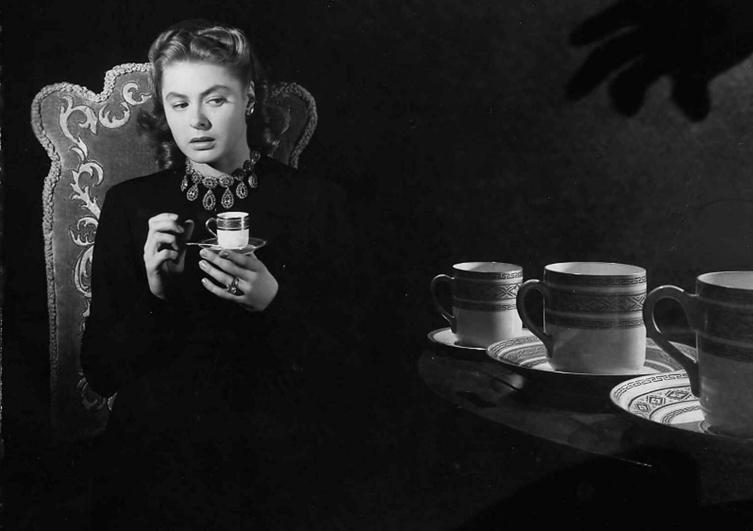 Ingrid Bergman in an eerie, shadowy room in a still from the classic film Notorious