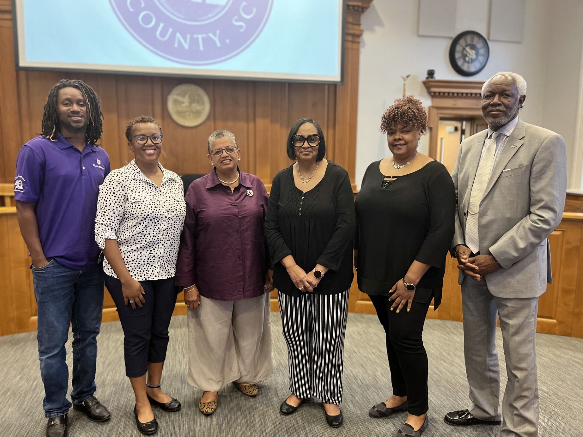 Members of the Morant family stand smiling in a line in Council Chambers