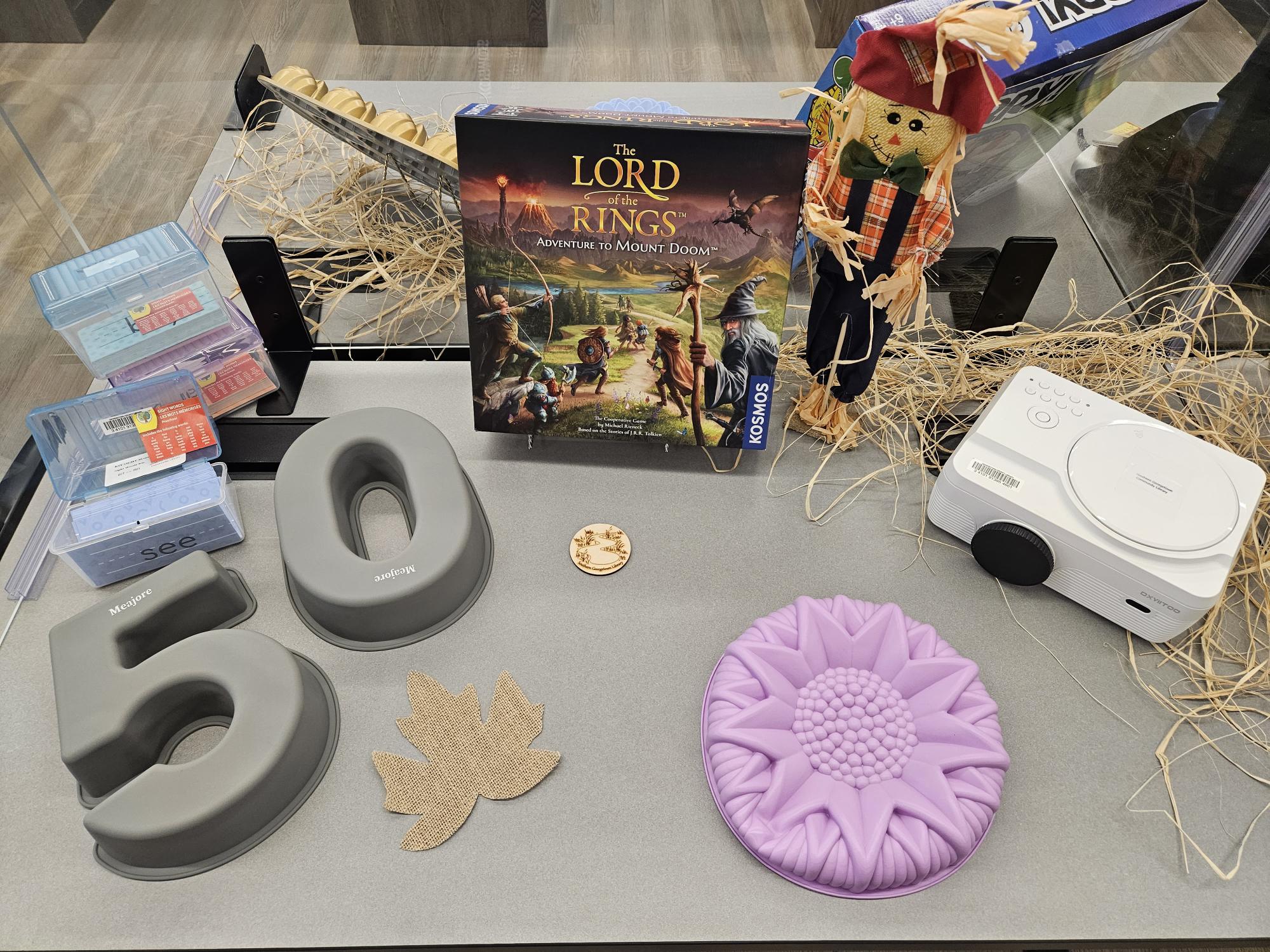 Assorted items from the Library of Things, including bakeware and games.