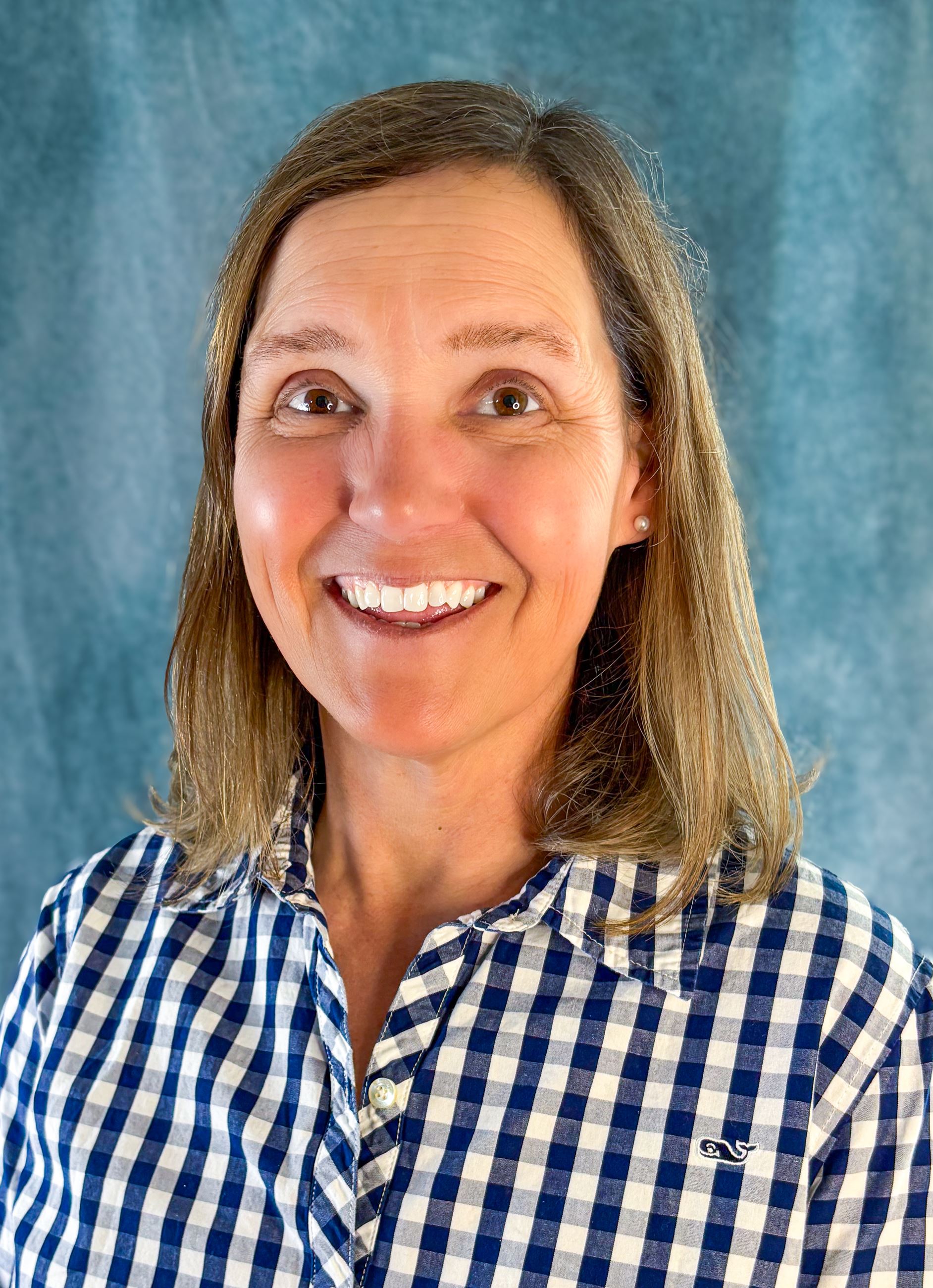 Amy King, a Caucasian woman with light brown hair, smiling.