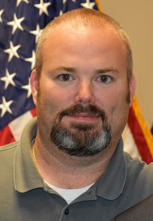 Portrait of Joseph Williamson in front of U.S. flag